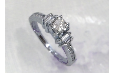 cushion cut diamond ring with sidestones and channel set