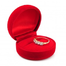 ring on top of red proposal box wedding ring inside a box