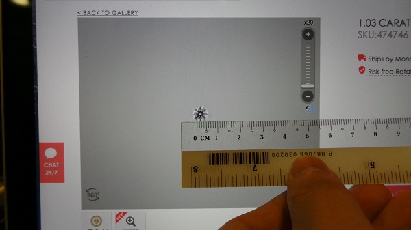 pressing ruler against the screen to estimate carat size