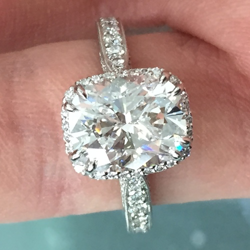 giant diamond ring with halo and cushion diamond