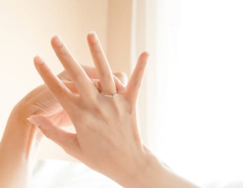 engagement rings on fingers