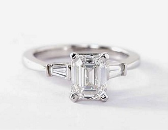 side stone baguette tapered design with emerald cut diamond