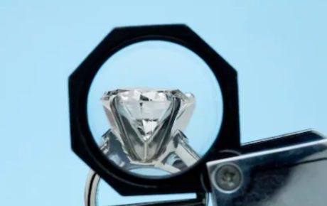 examining the girdle of a diamond engagement ring