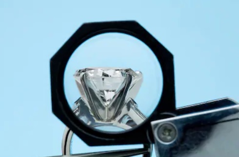 examining the girdle of a diamond engagement ring