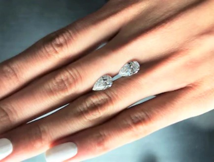 pear loose diamonds on finger pointed down