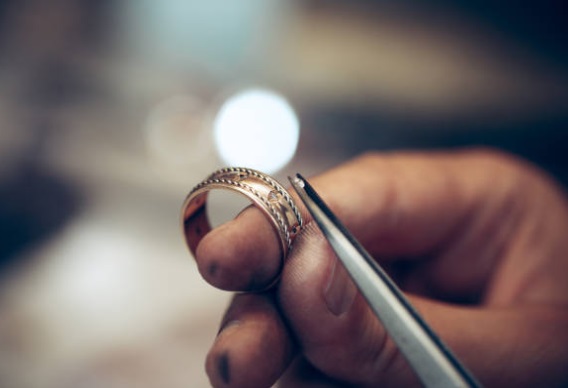 setting a diamond into a custom wedding bands