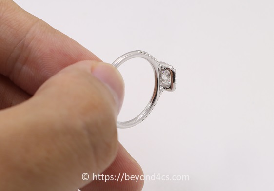 inspecting the underside of a diamond ring halo basket for finishing